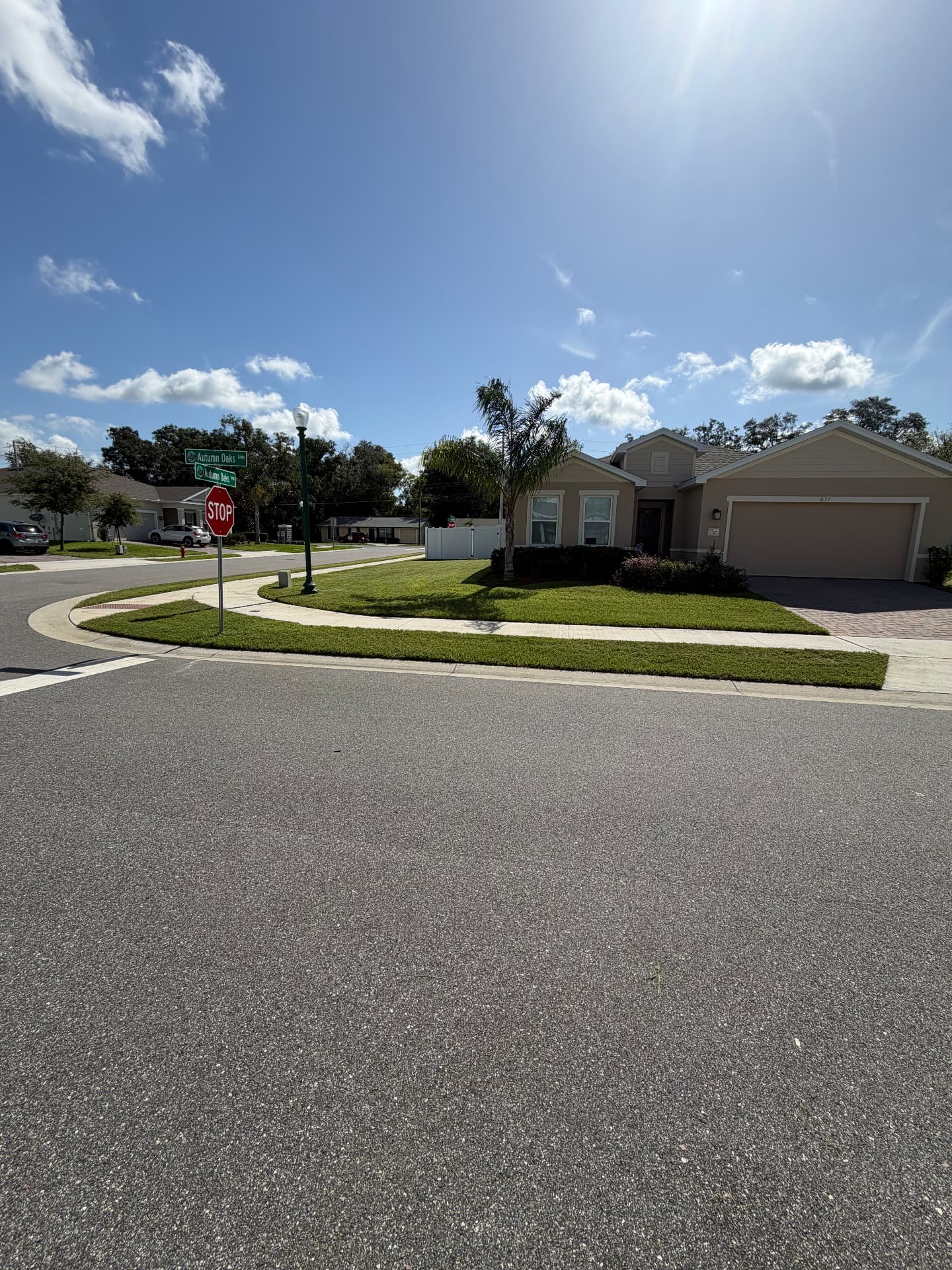 Same corner lot with a crisp, evenly cut lawn and clean edges after ProCutz service
